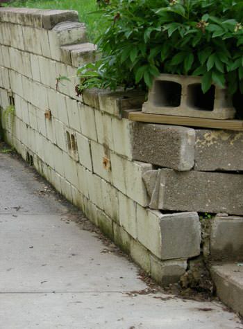 collapsing retaining wall with severe damage in Dawson Springs