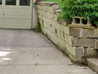 a failing retaining wall around a driveway in Evansville