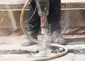 Jackhammering a slab floor in a Haubstadt home.