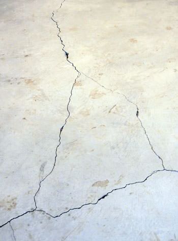 severely cracked, heaving slab floors in a home in Utica