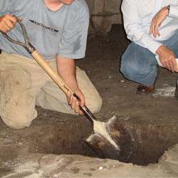 Digging a hole for the engineered fill used in a crawl space support system installation in Jasper