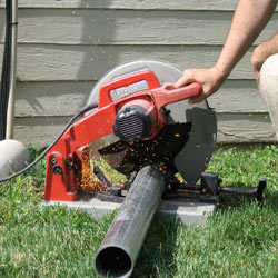 Cutting the support beam for a crawl space jack post outside a Washington home.