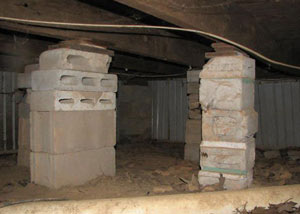 crawl space repairs done with concrete cinder blocks and wood shims in a Brandenburg home