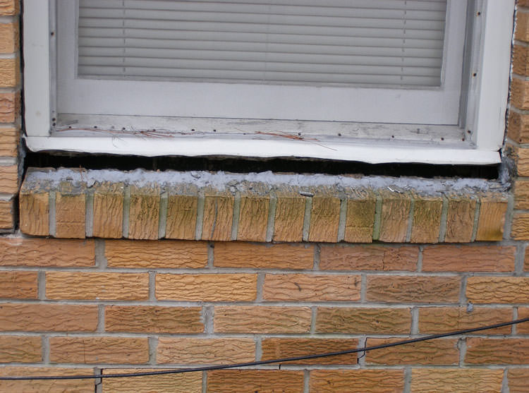 A window sill cracking and separating from the foundation wall in a Morganfield home.