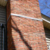 A tilting chimney on a Oakland City home with a leaning, tilting chimney that was temporarily repaired.
