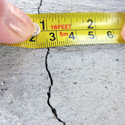 A crack in a poured concrete wall that's showing a normal crack during curing in Rockport