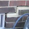 A closeup of a failed tuckpointing job where the brick cracked on a Mount Vernon home.