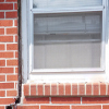 A gap in a window along the outer wall due to foundation settlement of a Spottsville home.