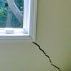 A long, diagonal crack that begins at a window corner of a Huntingburg home