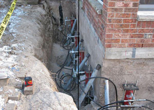 Foundation push piers installed around a house with a foundation settlement issues in Hardinsburg