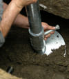 Henderson helical pier installation nearing completion, with the blade being advanced into the foundation soils.