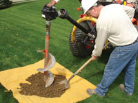 Auguring a hole in the earth for a foundation wall repair system in Washington