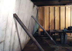 A severely tilting foundation wall propped up by steel beams in Mount Vernon.