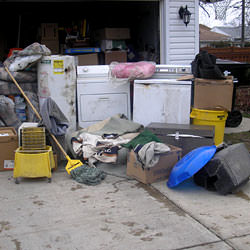 Soaked, wet personal items sitting in a driveway, including a washer and dryer in Jasper.