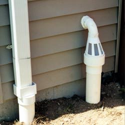 A grated sump pump discharge line fitting in Philpot
