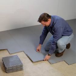 basement subfloor tiles being installed by a contractor in Utica