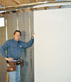 Installing wall panels on top of our basement wall insulation in Jasper