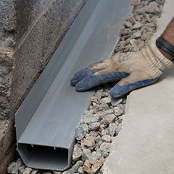 installing a drain tile system in a Dawson Springs home